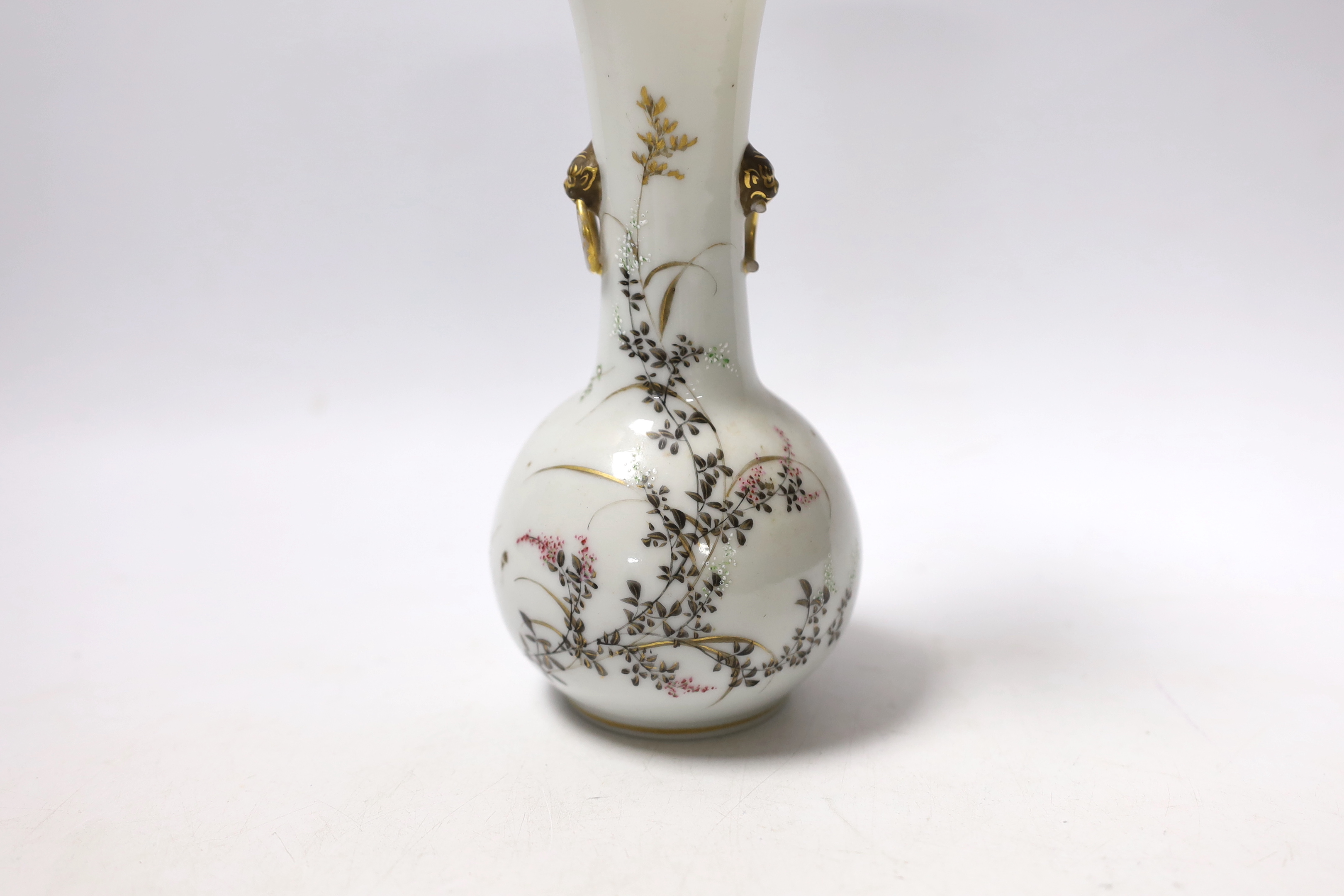 A Japanese bottle vase with lion mask and ring handles, together with a hardstone disc